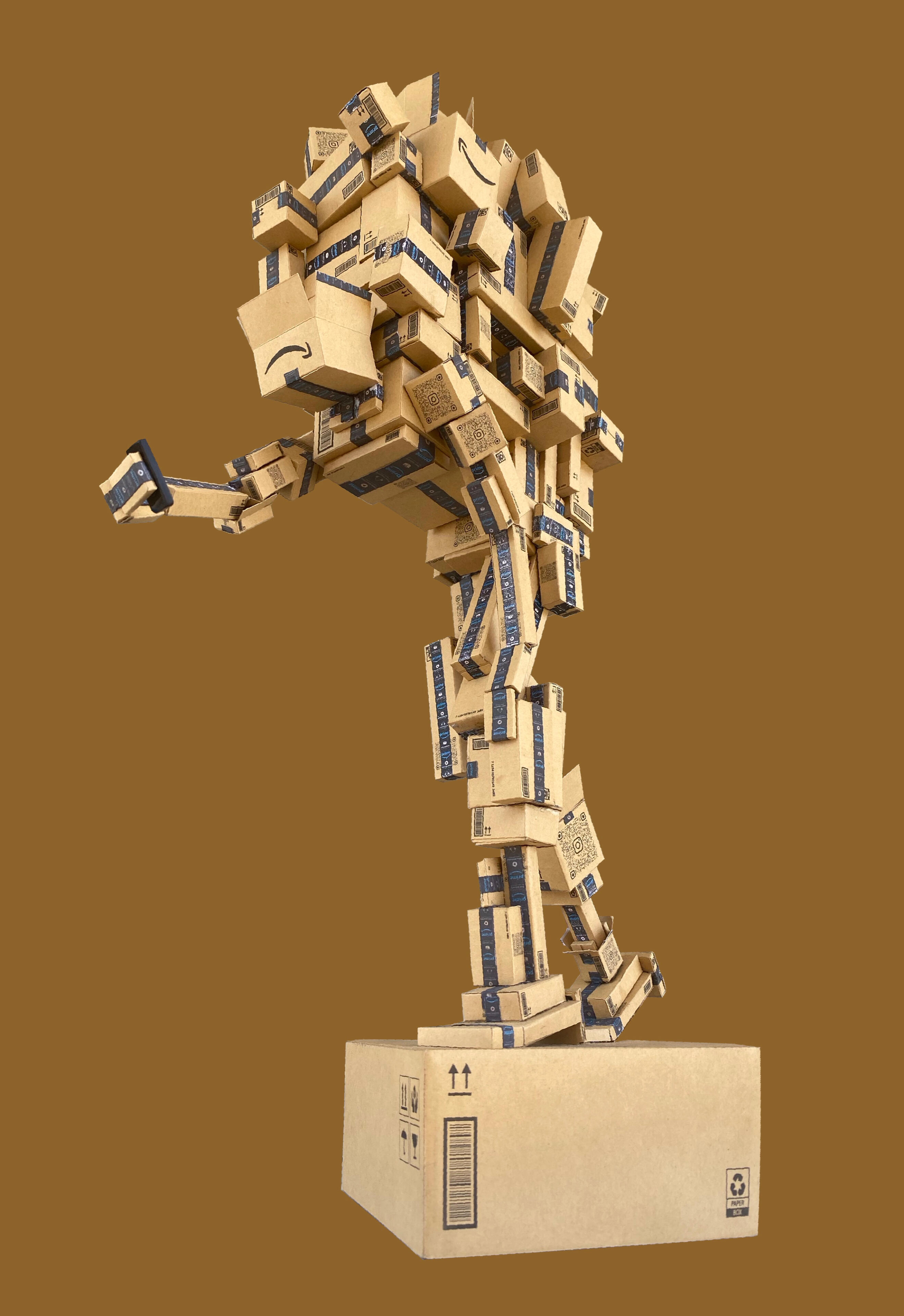 Black sculptural form resembling stacked tires on a white background.