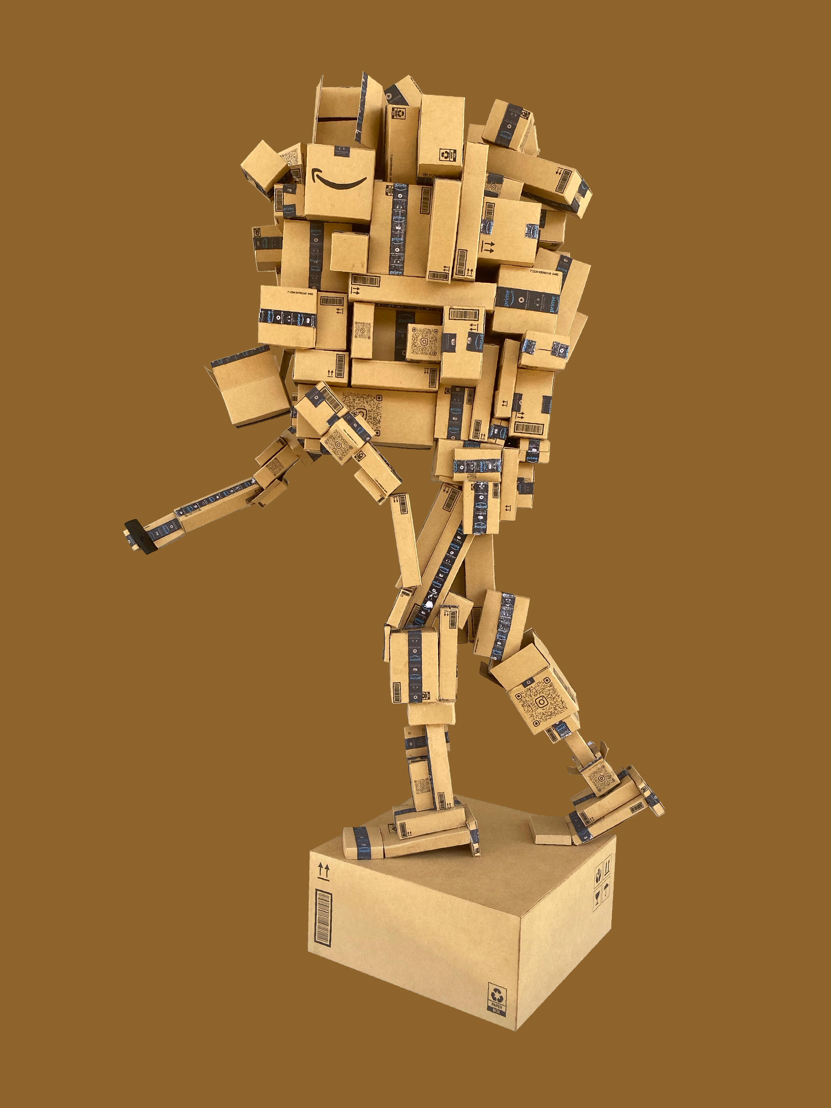 Black sculptural form resembling stacked tires on a white background.