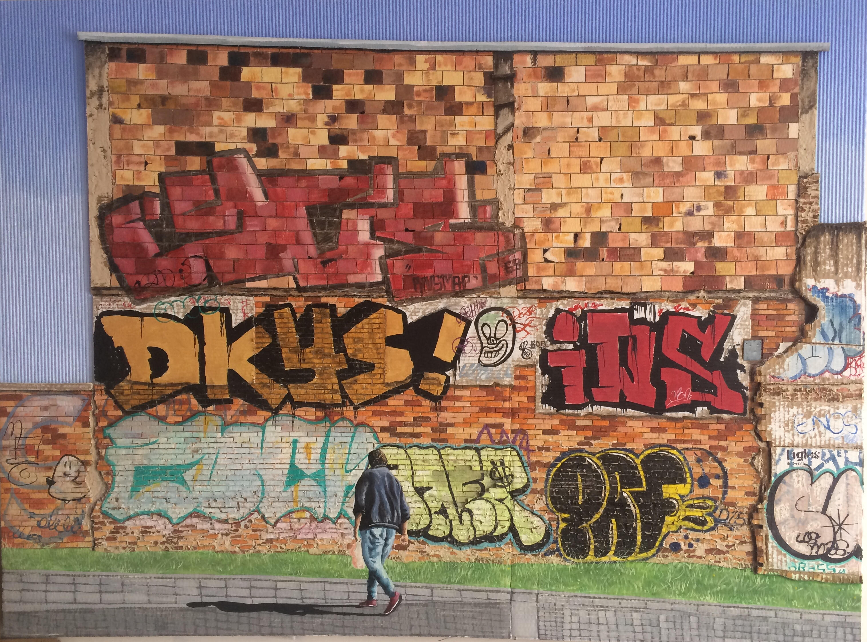 Black sculptural form resembling stacked tires on a white background.
