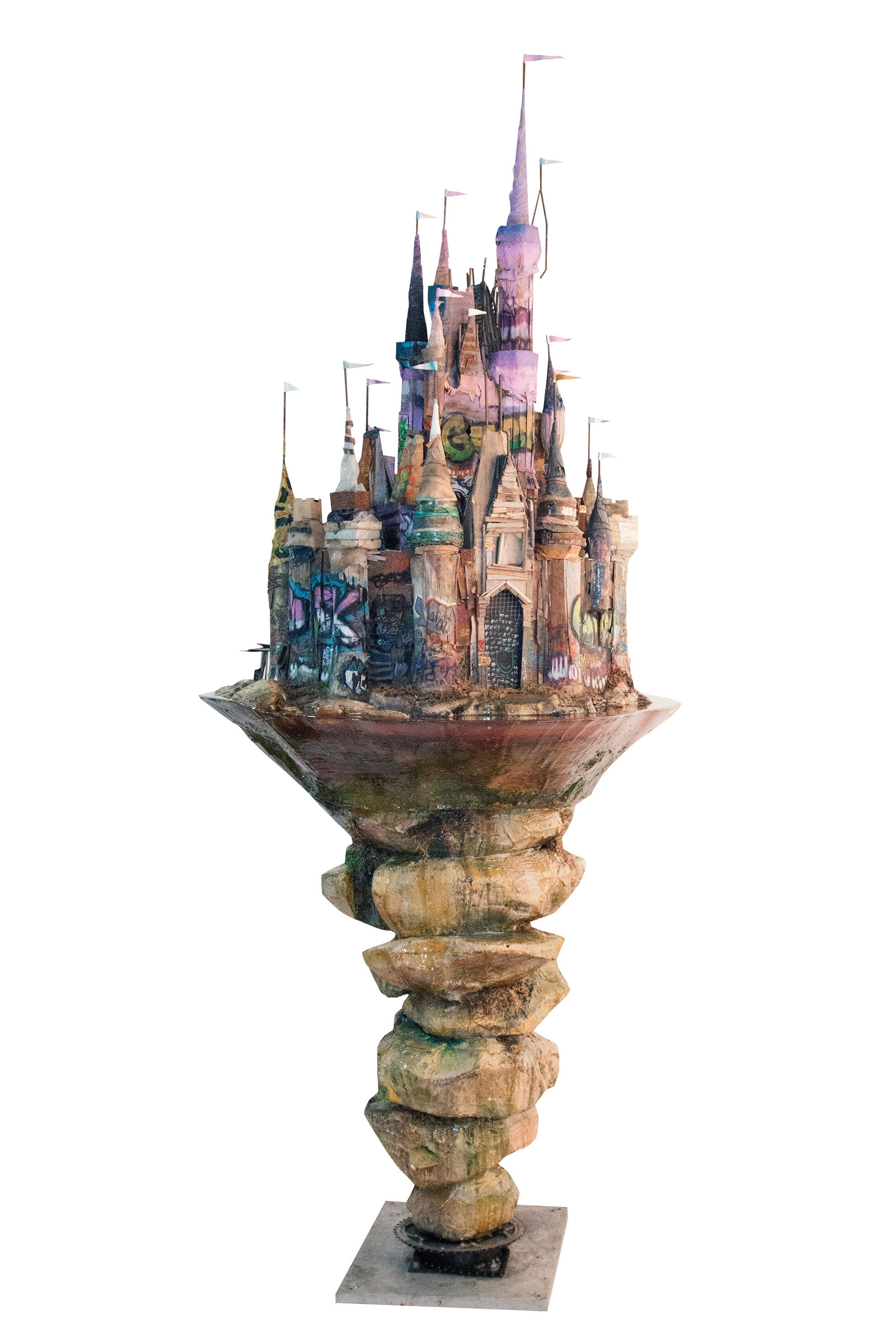 Black sculptural form resembling stacked tires on a white background.