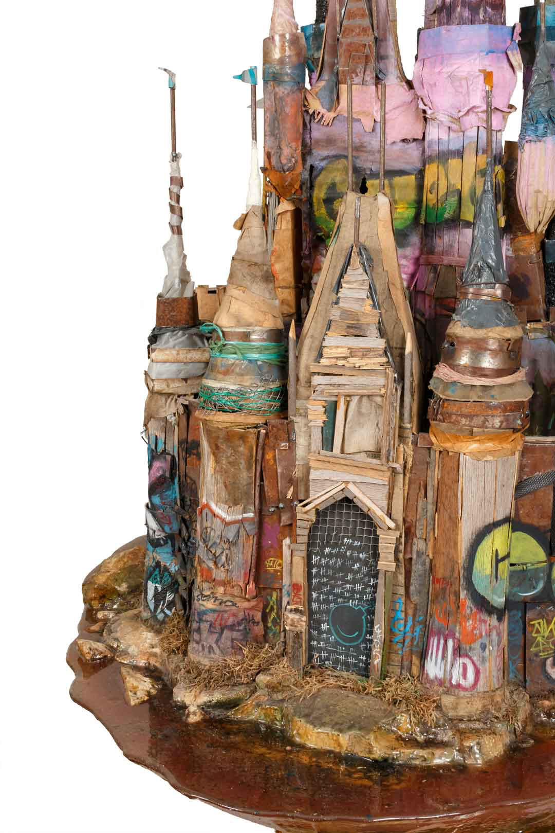 Black sculptural form resembling stacked tires on a white background.